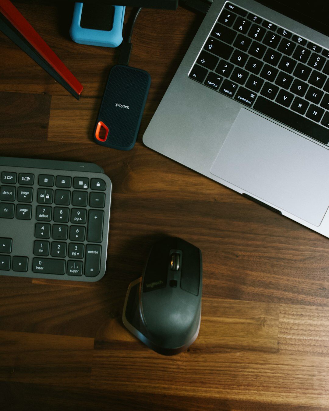 German male editor typing on a laptop with a news dashboard on screen